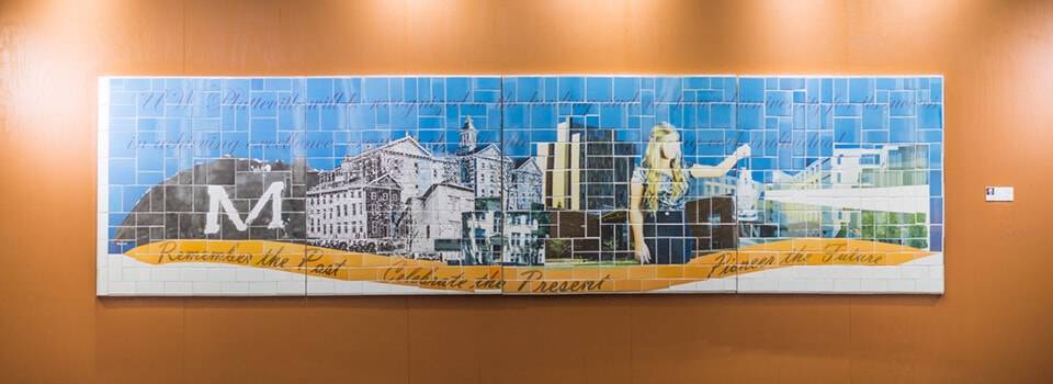 Platteville Over Time — a 4 by 16 foot ceramic tile mural showing the University of Wisconsin–Platteville's history from founding to future, with the text Remember the Past, Celebrate the Present, Pioneer the Future